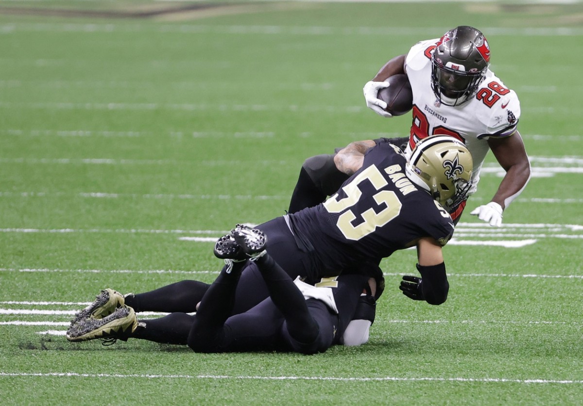 Jan 17, 2021; New Orleans, LA, USA; Buccaneers running back Leonard Fournette (28) is tackled by Saints linebacker Zack Baun (53) during the first quarter in a NFC Divisional Round playoff game at Mercedes-Benz Superdome. Mandatory Credit: Derick E. Hingle-USA TODAY Sports